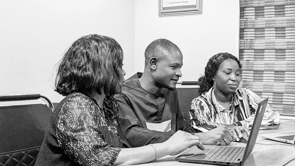 CentreLSD staff analysing programme information using laptops